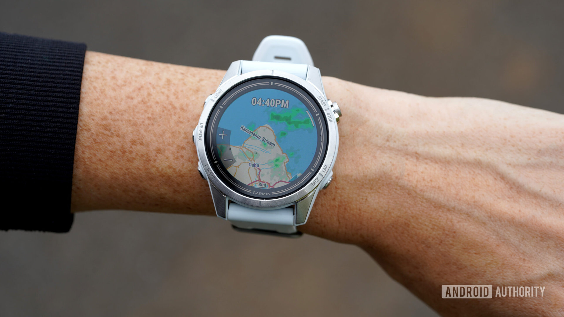 A Garmin Epix Pro displays a map of Oahu with a weather overlay.