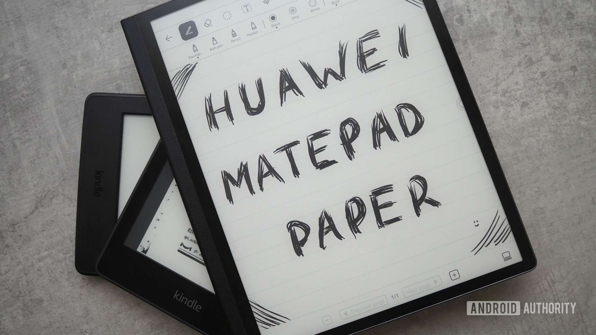 HUAWEI MatePad Paper with a sketched note showing the name of the device, on top of two other Amazon Kindles