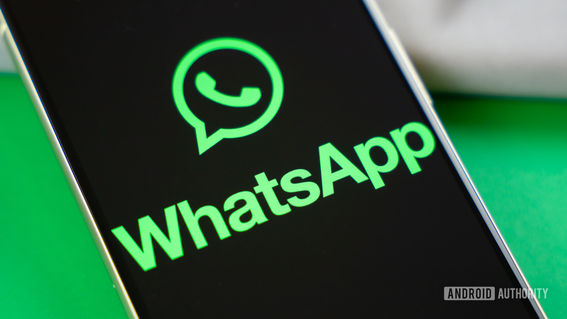 WhatsApp logo on smartphone next to everyday accessories Stock photo 2